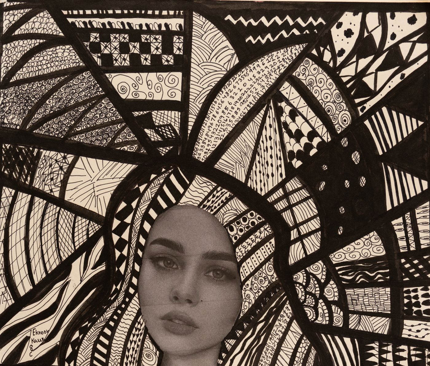 A printed face surrounded by hand-drawn ink patterns